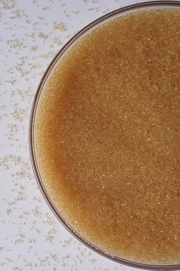 A bowl of light yellow ion exchange resins.