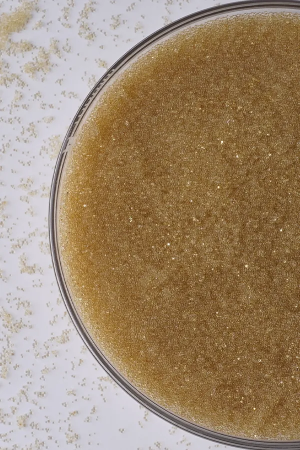 A bowl of light yellow mixed bed resins.